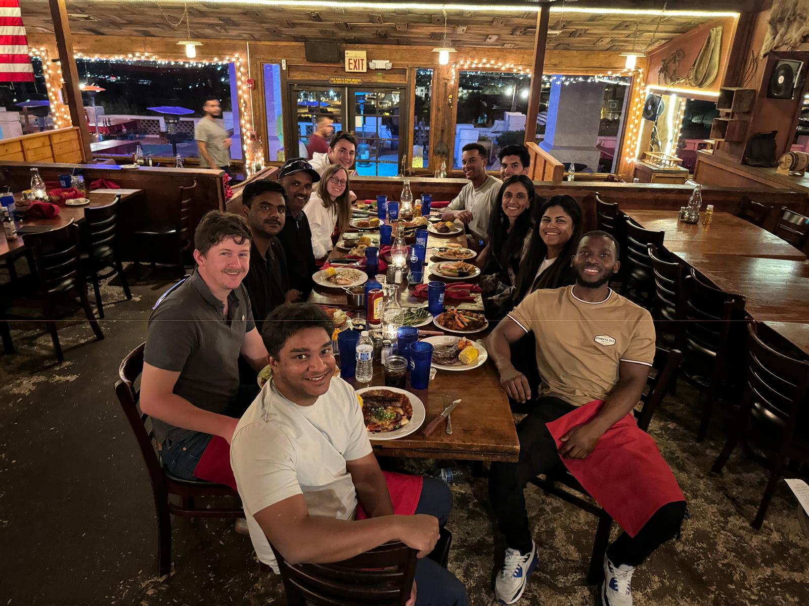 Chicago Booth golf community enjoying dinner together, showing lasting friendships