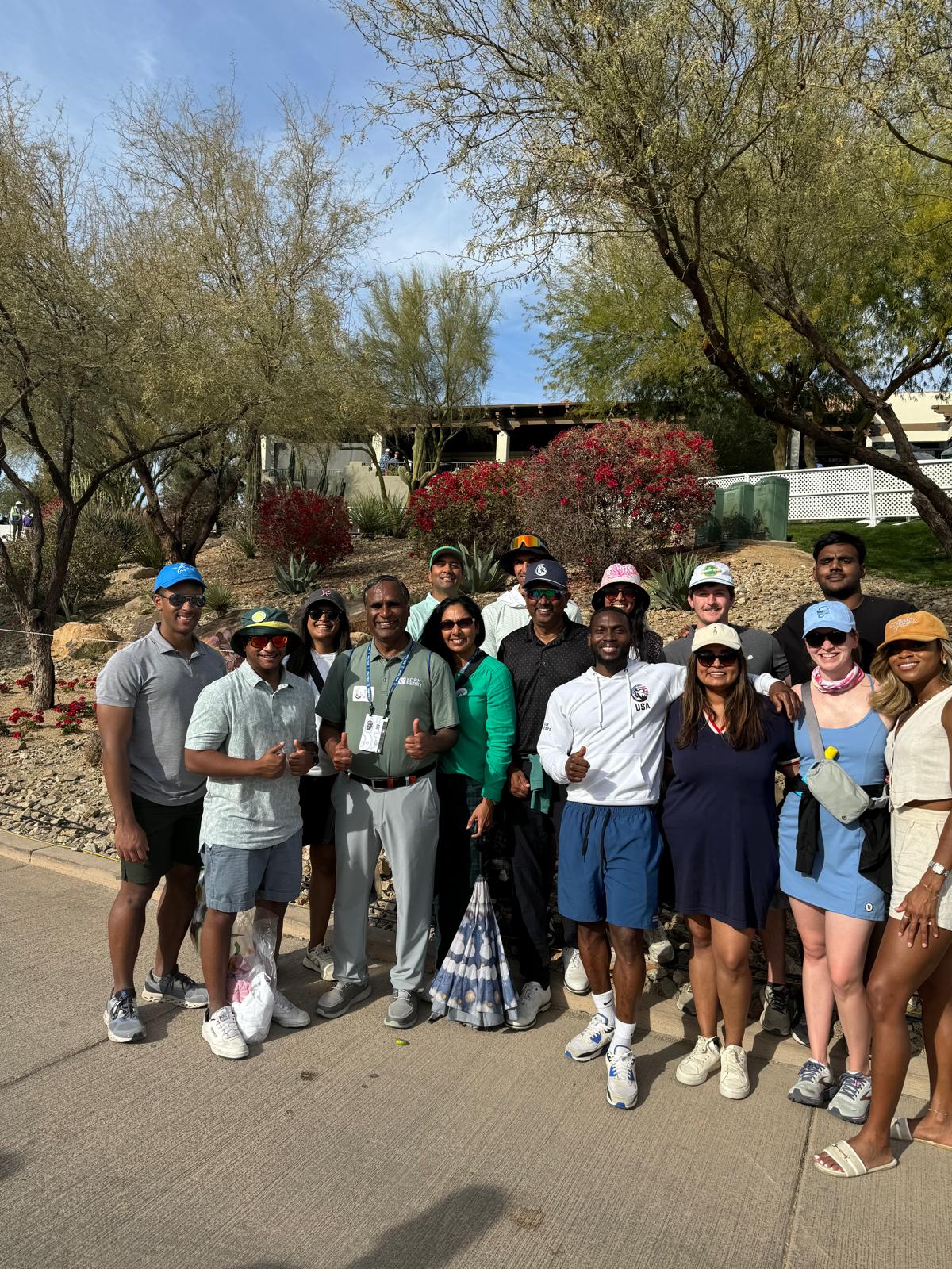 Chicago Booth MBA students at desert golf tournament with beautiful Arizona landscaping