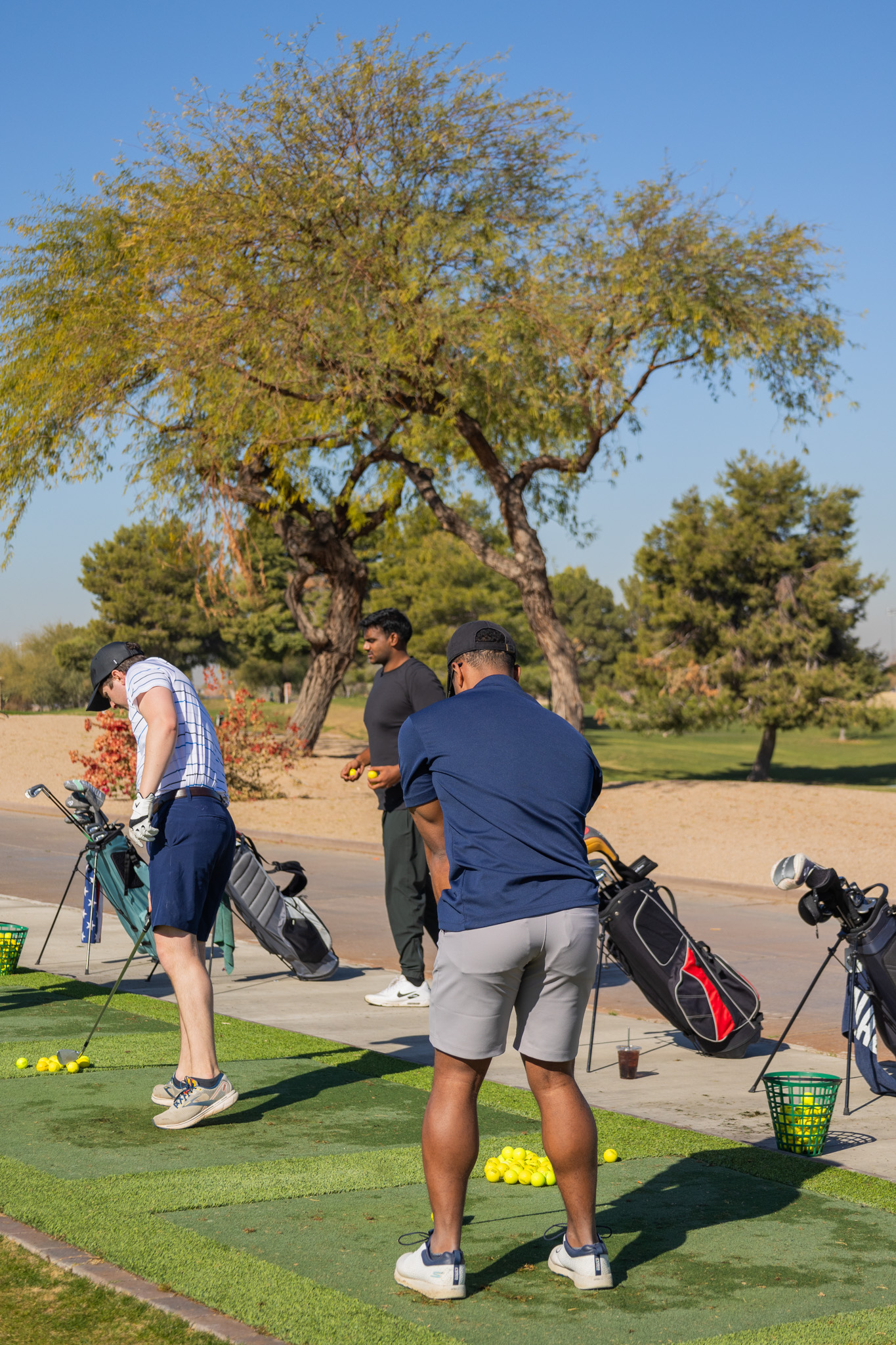 Golfers practicing at the driving range during training session