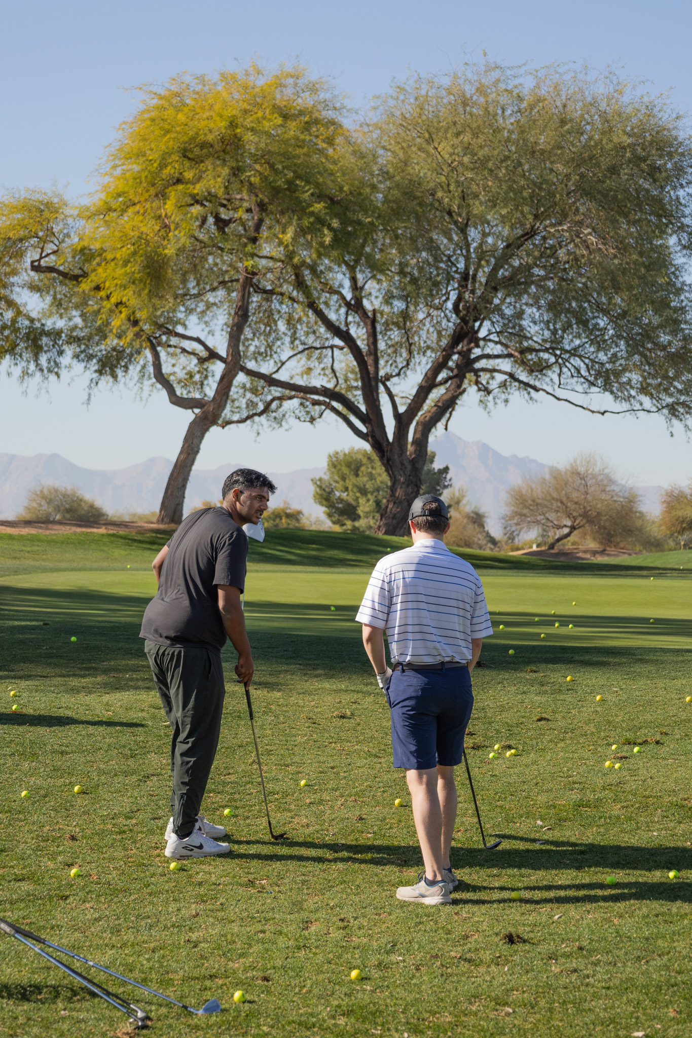 Short game instruction with practice balls on outdoor facility