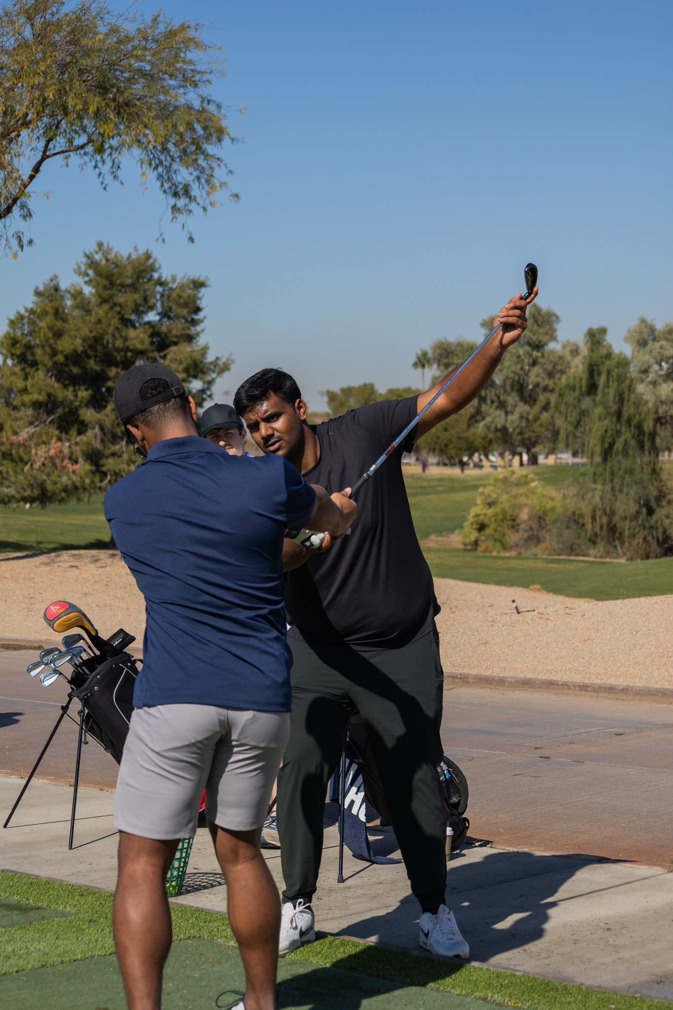 Hands-on swing instruction with physical guidance from coach
