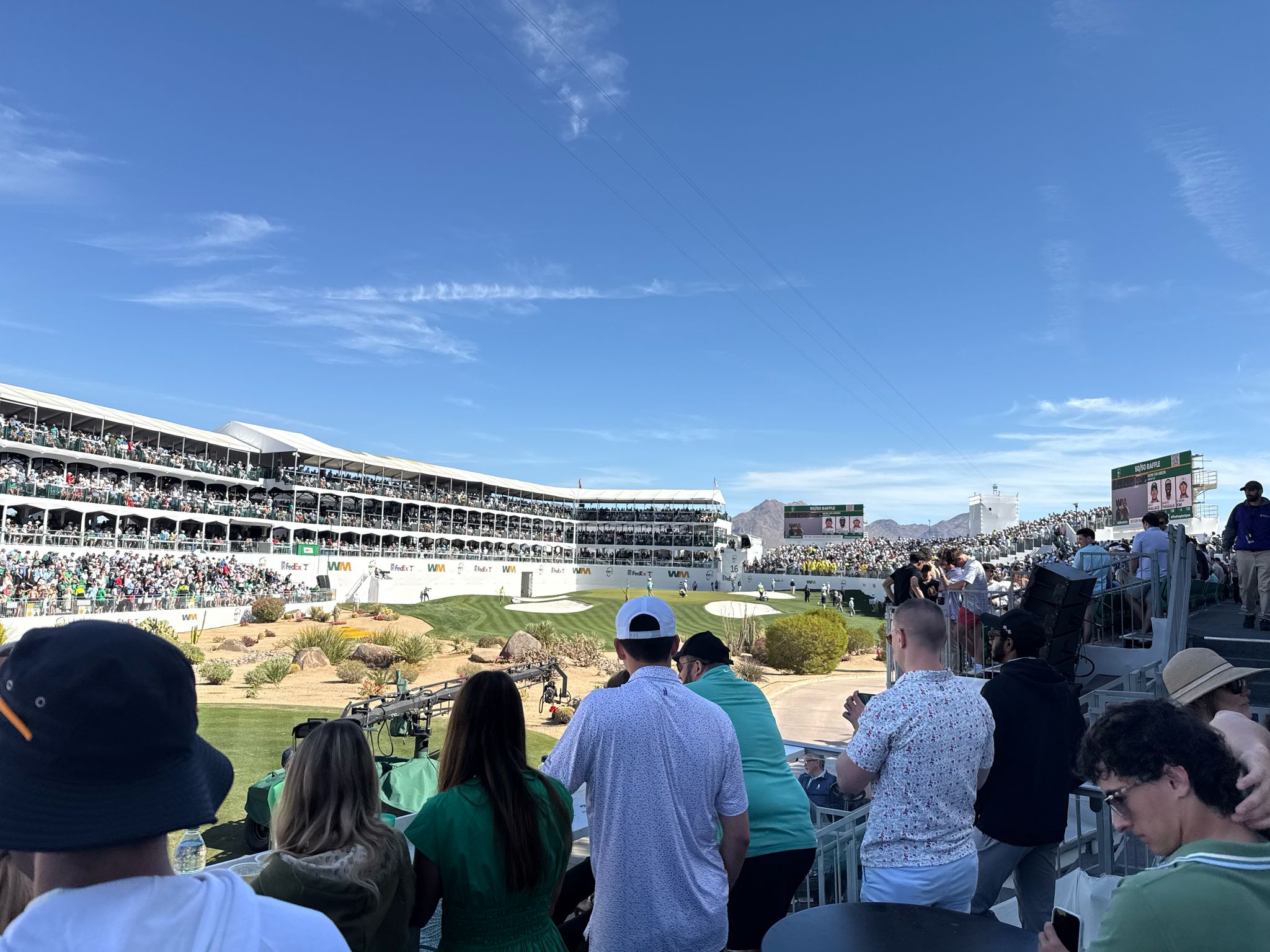 Stadium view of WM Phoenix Open showing massive crowds and tournament atmosphere